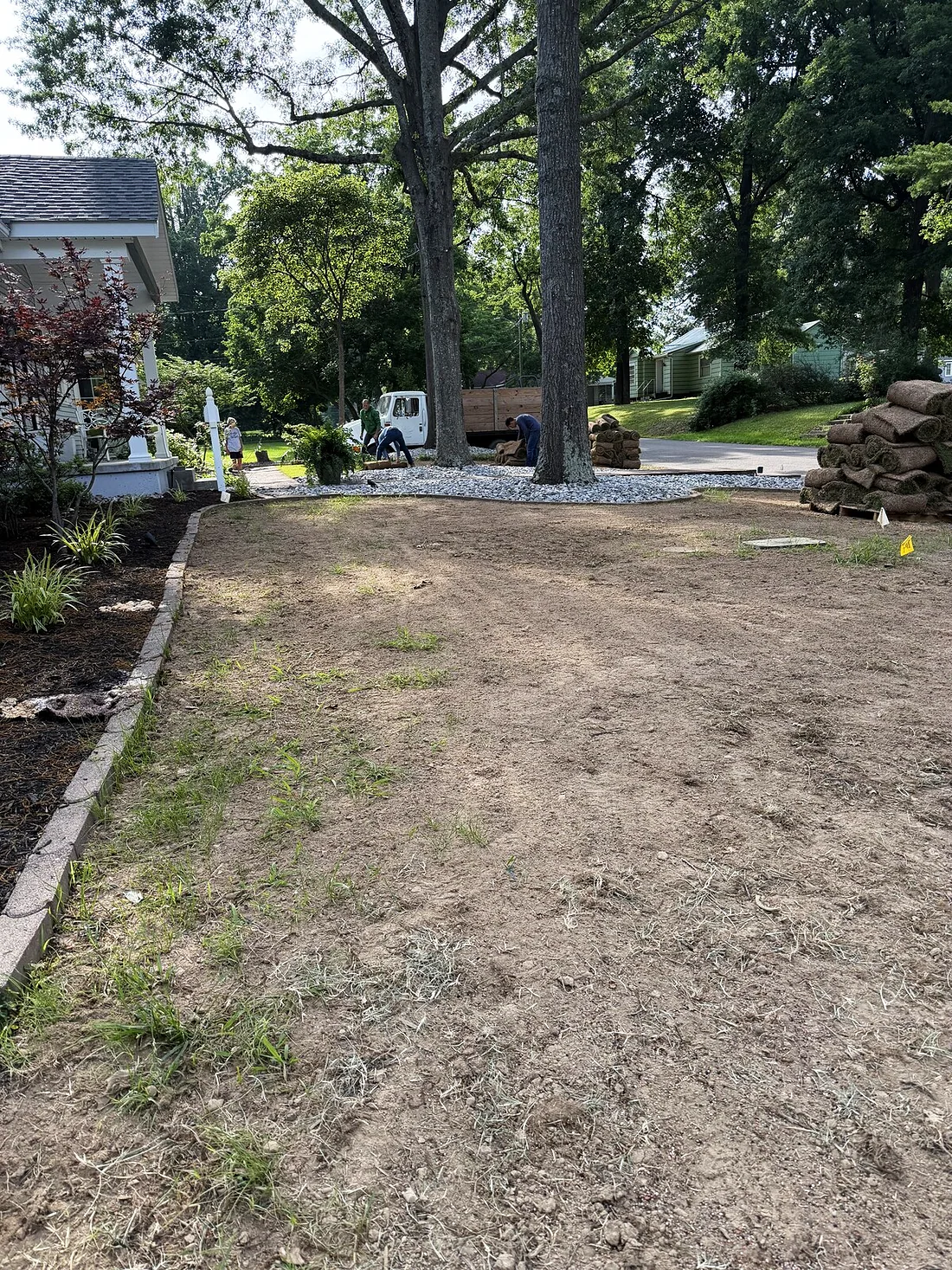 Before — bare graded soil across the front yard