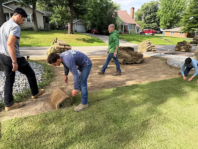 Crew laying pallet sod