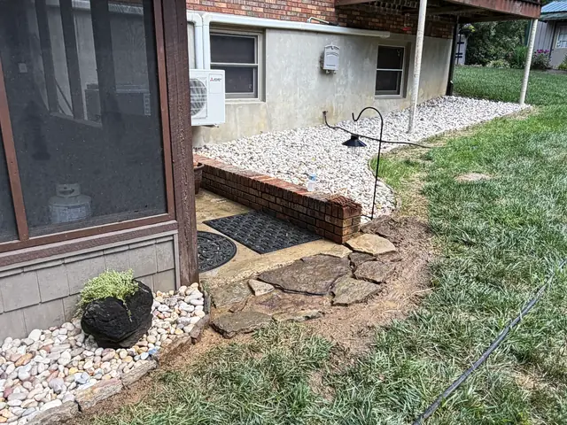 Stone patio and seating area on a finished property