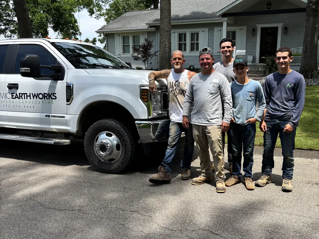 The Dynamic Earthworks crew standing with the company truck on a finished job